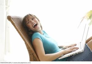 Girl using laptop computer and laughing